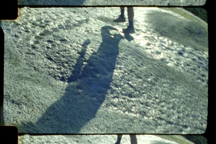 Legs of a person walking on rocky ground