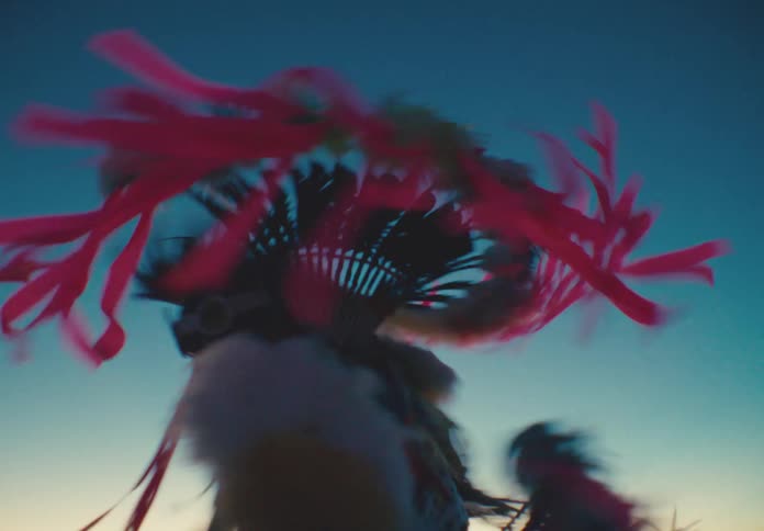 Native american man wearing traditional dress dancing