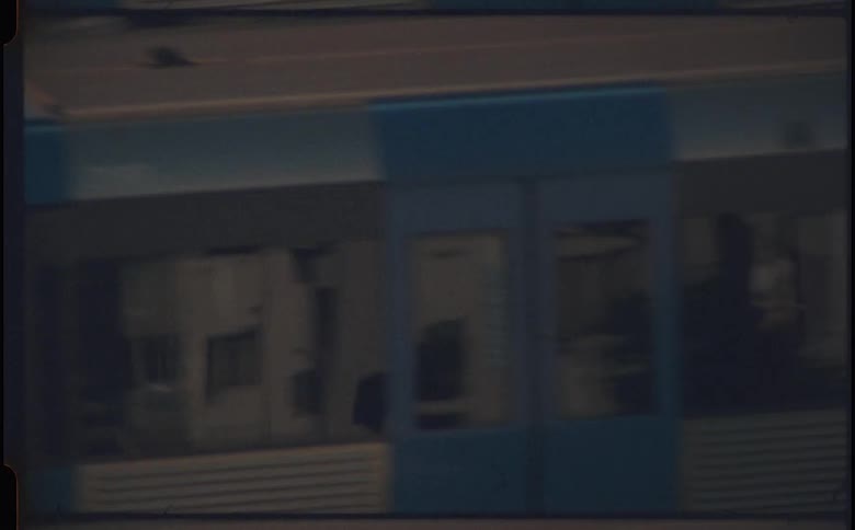 A zoomed clip of a blue train moving