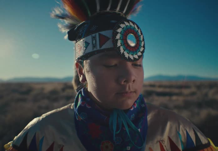 Portrait of a young teenage boy wearing colorful native american clothing