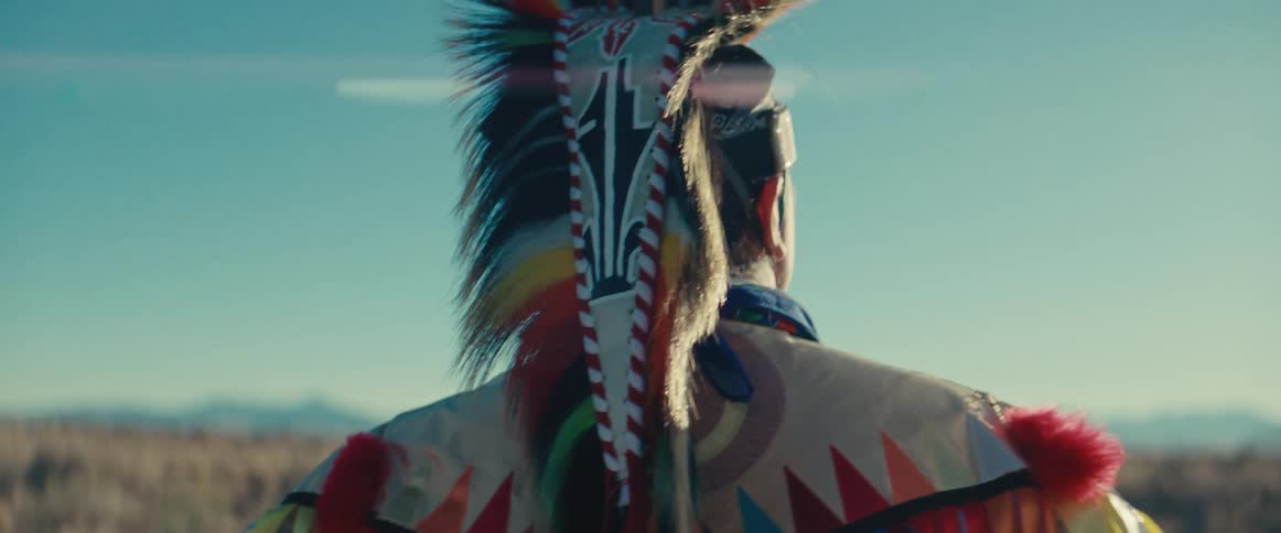 Person from behind wearing native american attire