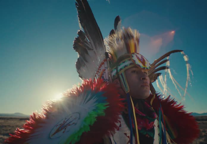Man dressed in traditional native american clothing in a natural setting