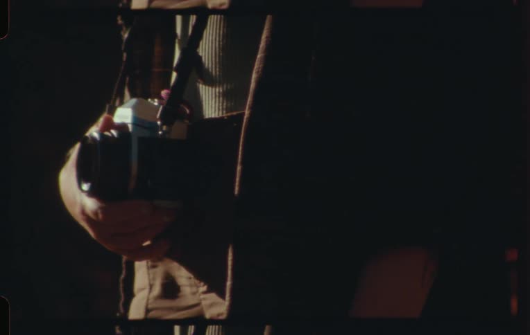 Persons hand holding a camera