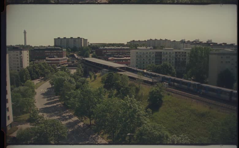 Urban city with residential buildings and a passing train