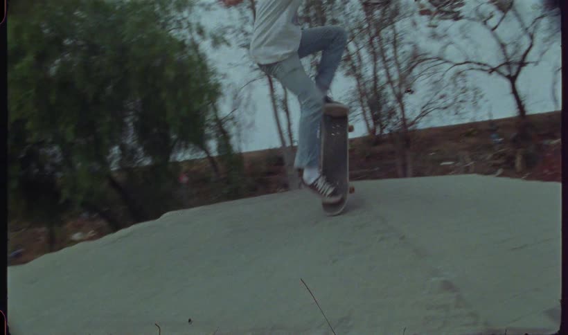 Man on a track doing a trick with a skateboard