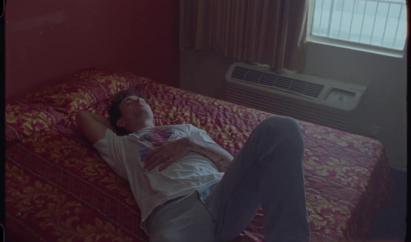 Man lying in bed getting up