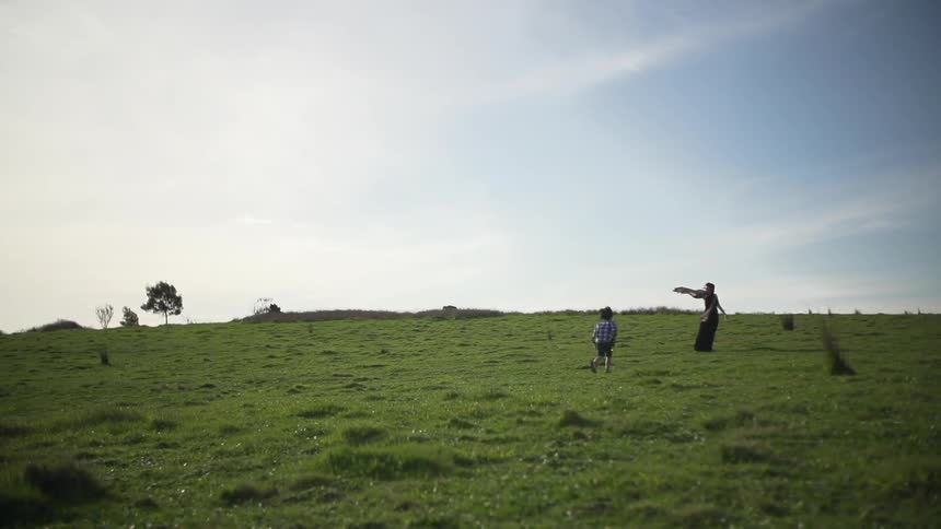 People playing on an empty field on a sunny day