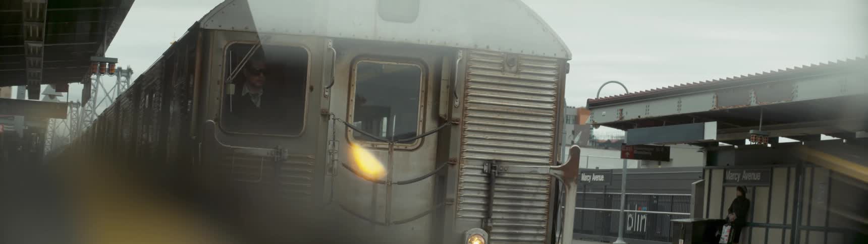 A train has a conductor in the window
