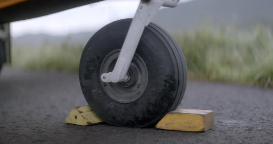 A wheel is held in place by some wooden blocks