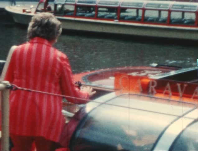 Elderly lady getting into a boat