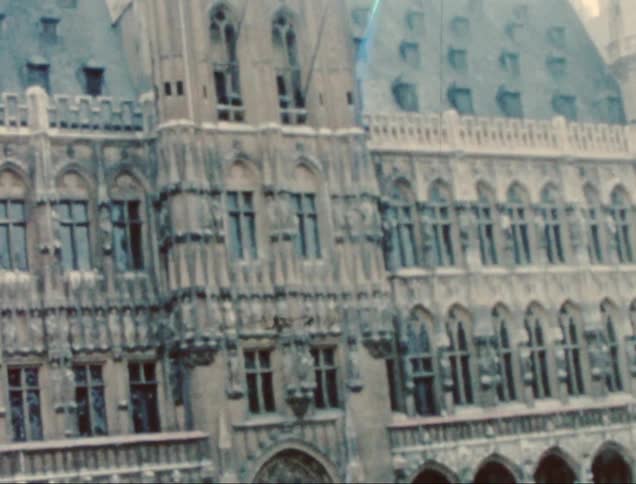 A historic building with intricate architectural details and a tall tower