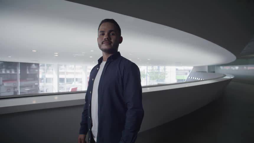 Man wearing a blue shirt inside a building