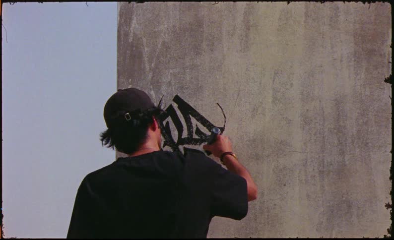 Man graffitiing a wall