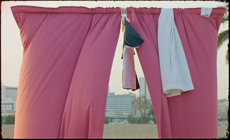 The wind blows the curtains hanging outside