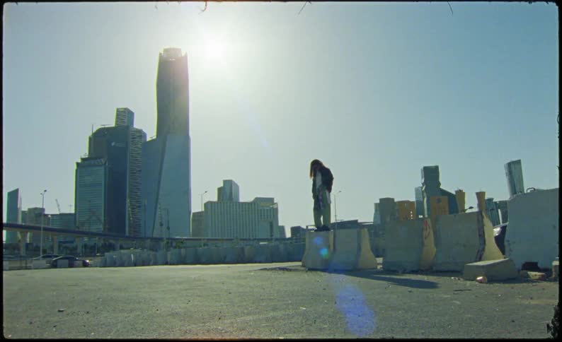 A woman is dancing in front of the skyline