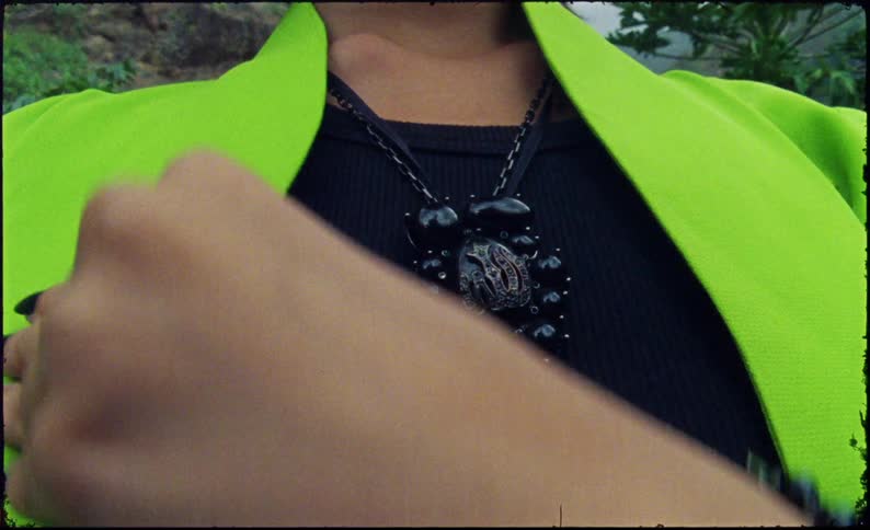 A woman adjusts her clothing outside