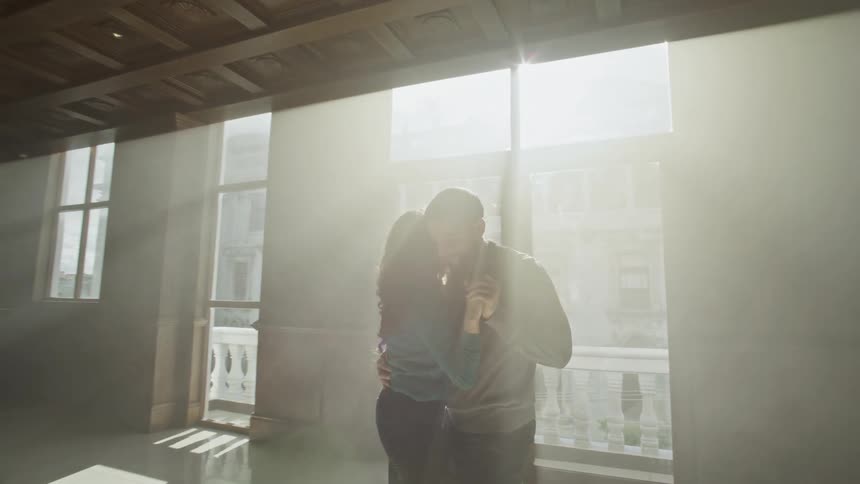 Man and woman in an indoor space dancing together