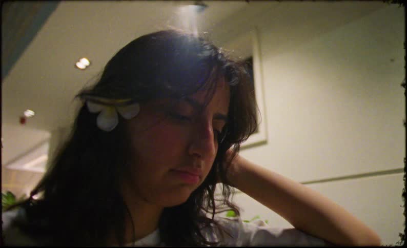 A teenage girl adds a flower to her hair