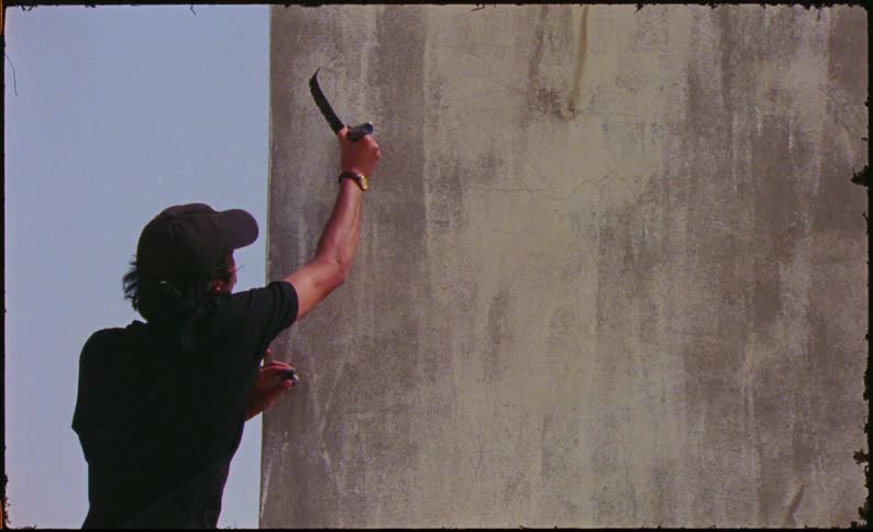 Man graffitiing on a wall