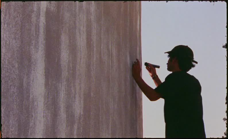 Man drawing on a wall