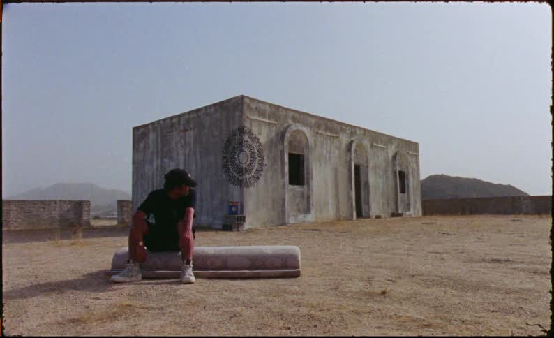 A man sits down outside the shelter