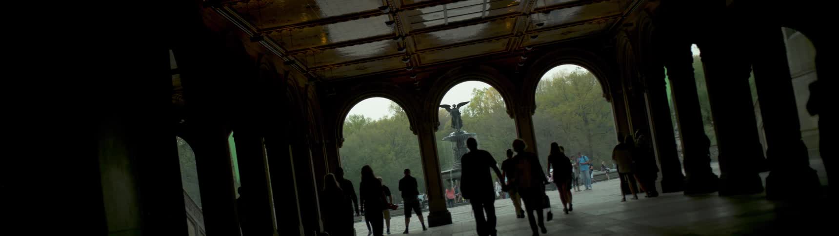 Still image of a crowd of people in a courtyard