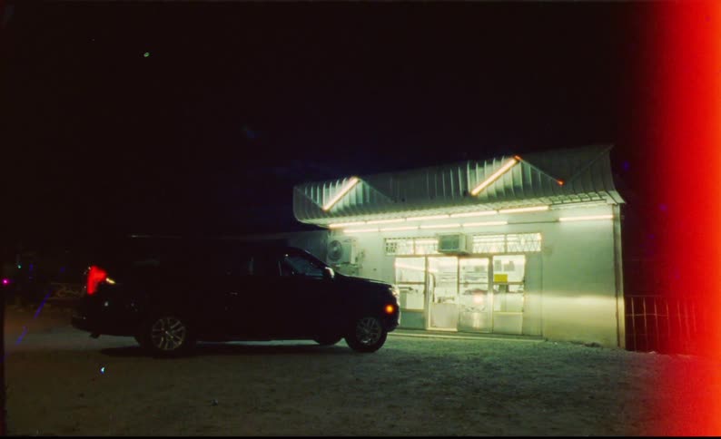 Suv vehicle in front of a convenience store at night