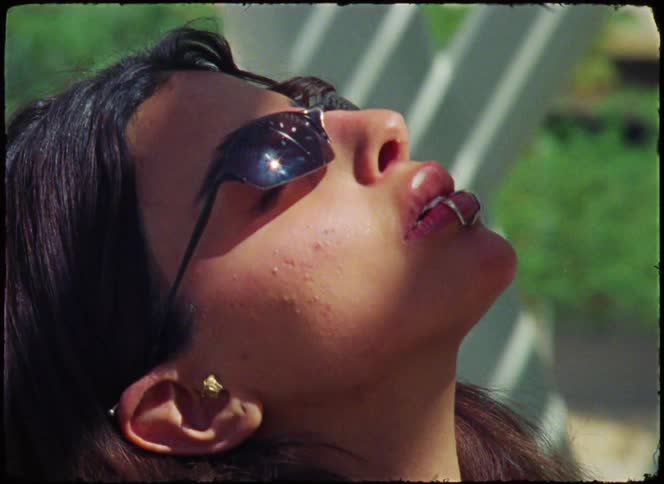 Young woman with sunglasses looking up