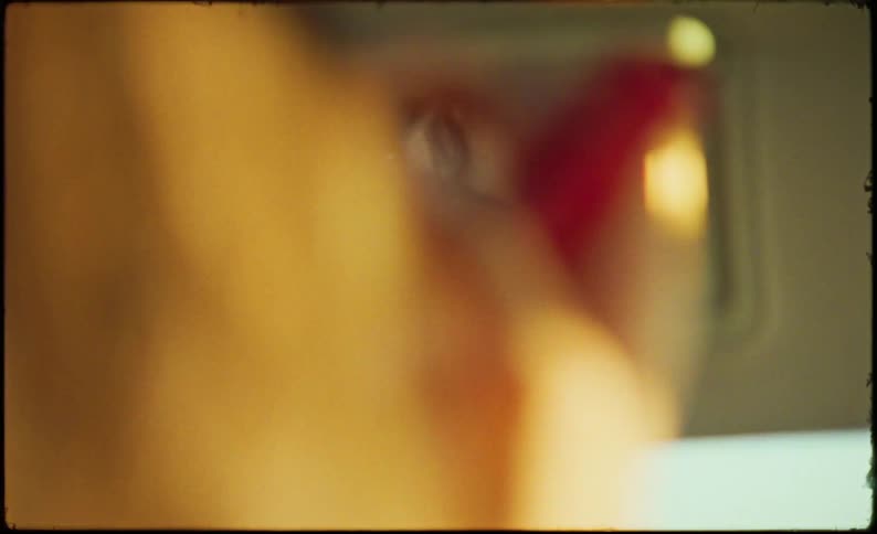 A woman looks at her face in the mirror