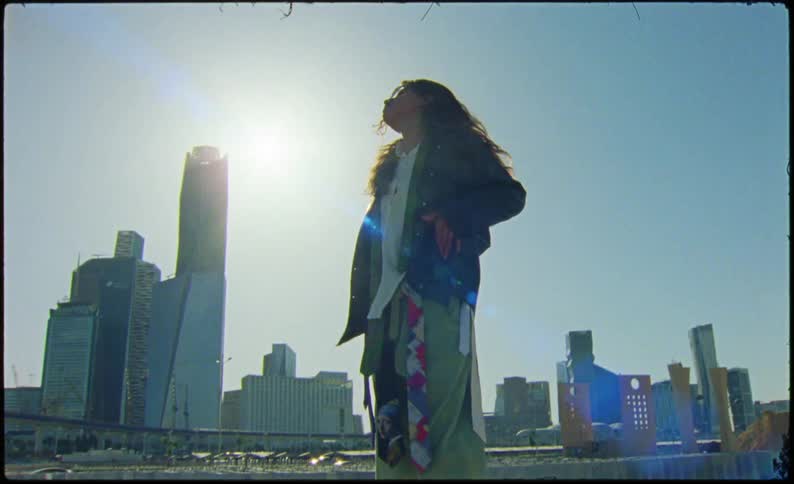 Woman in a black jacket in an outdoor space