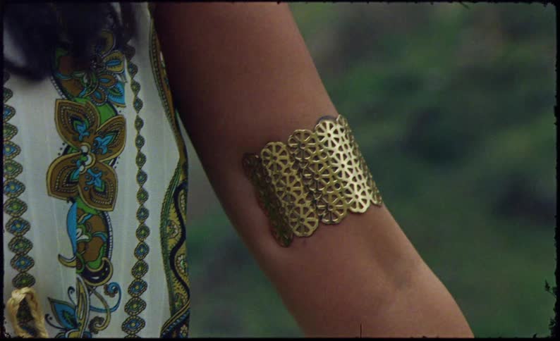 Golden bracelet on a womans arm
