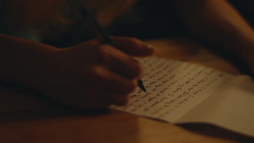 A person reads a written letter then closes it and walks away