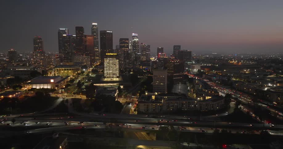 A beautiful aerial view of the los angeles skyline at night with tall skyscrapers illuminated against a dark sky