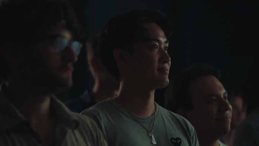 Men in an indoor space clapping