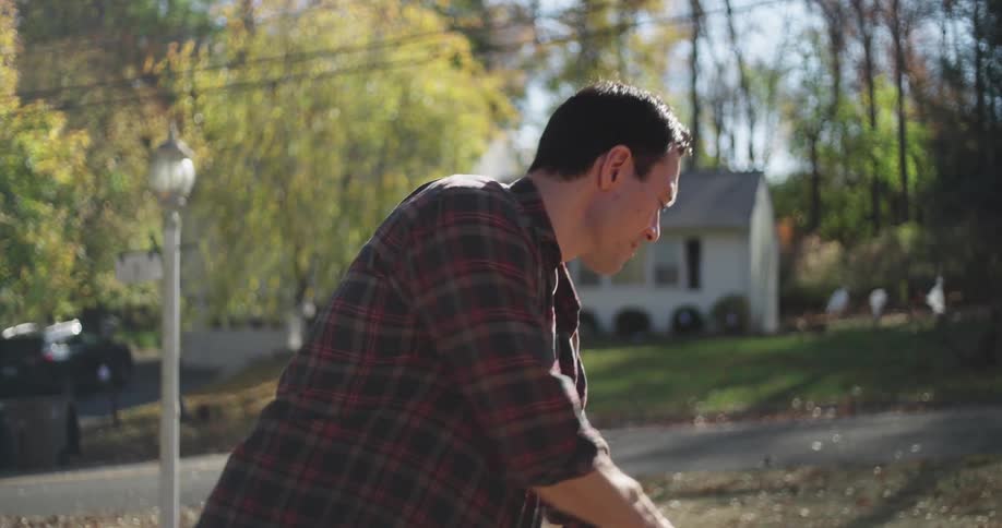 Man in a yard cleaning