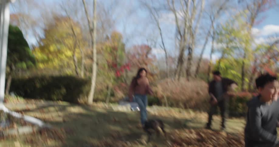 Children run out of the house and play in the leaves