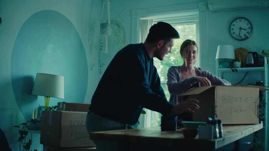 A footage of couples unboxing a package in the kitchen