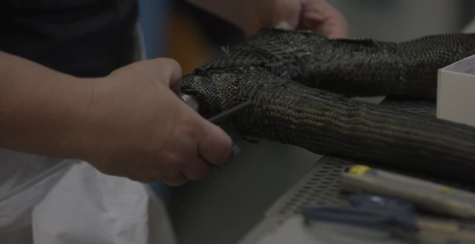 A factory employee works on assembling an object