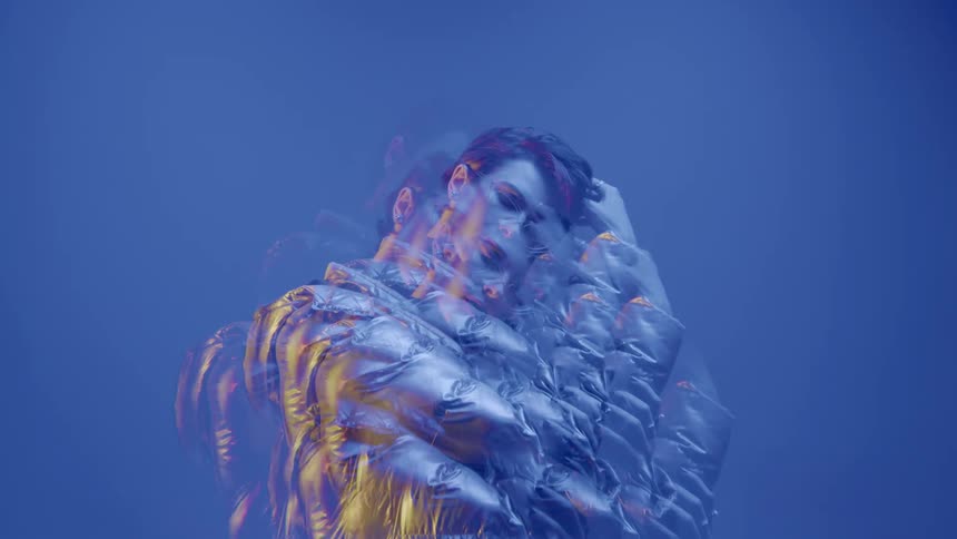 Portrait of a female model in multiple exposures wearing a gray jacket