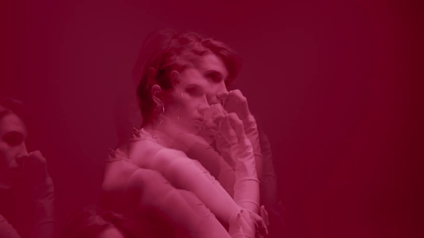 A woman is waving her arms around in the haze