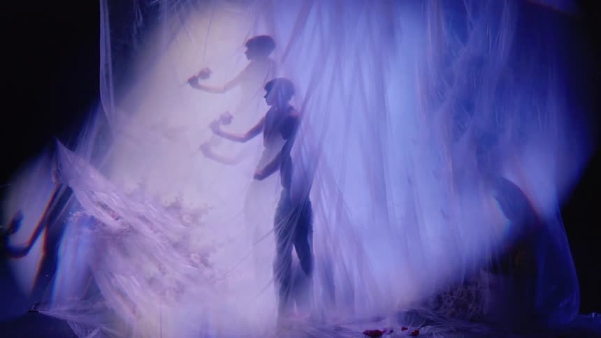 A surreal scene with the silhouette of a person in a predominantly purple and blue color palette