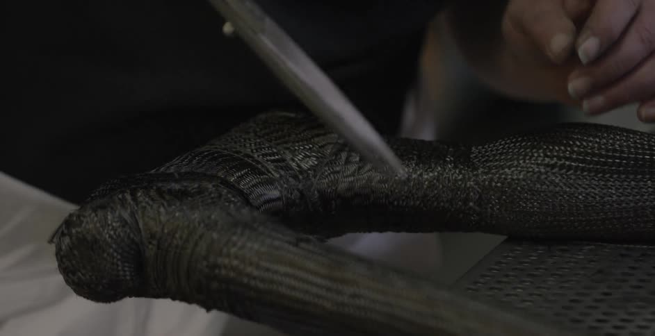 Person cutting fabric on an object