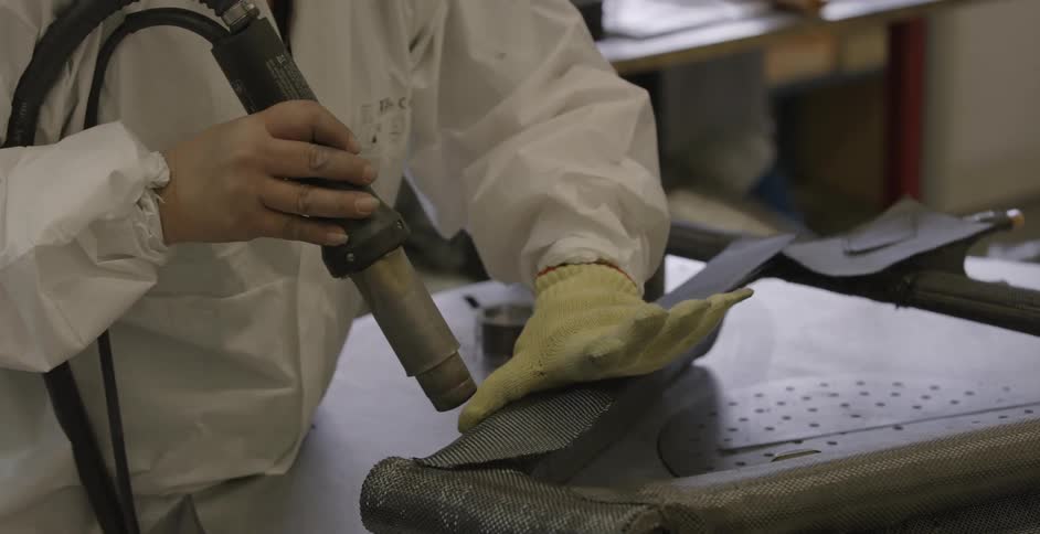 A person is using a tool to apply something