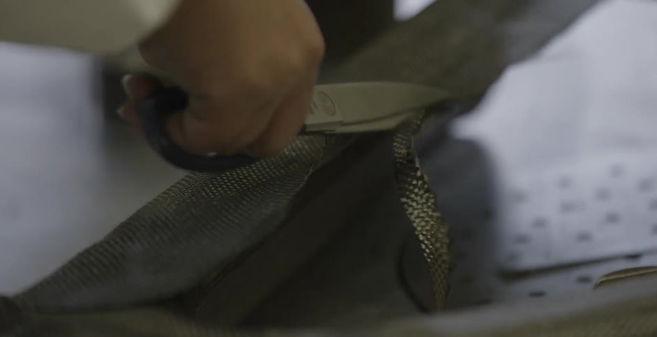Person using snips  to cut a braided material