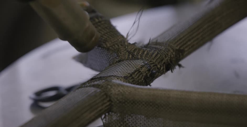 Person glues fabric and pats it down while wearing yellow gloves