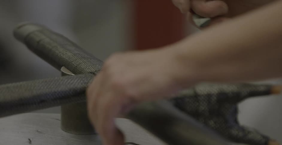 A man uses scissors to cut a string