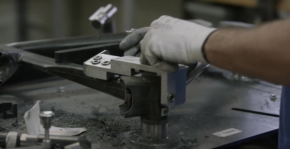 A person is working in a shop with tools