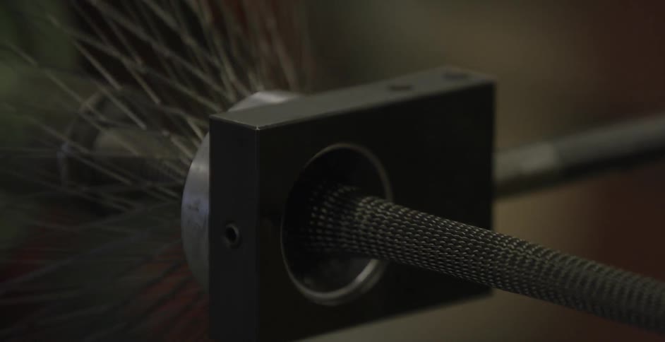 A factory machine assembles a tube