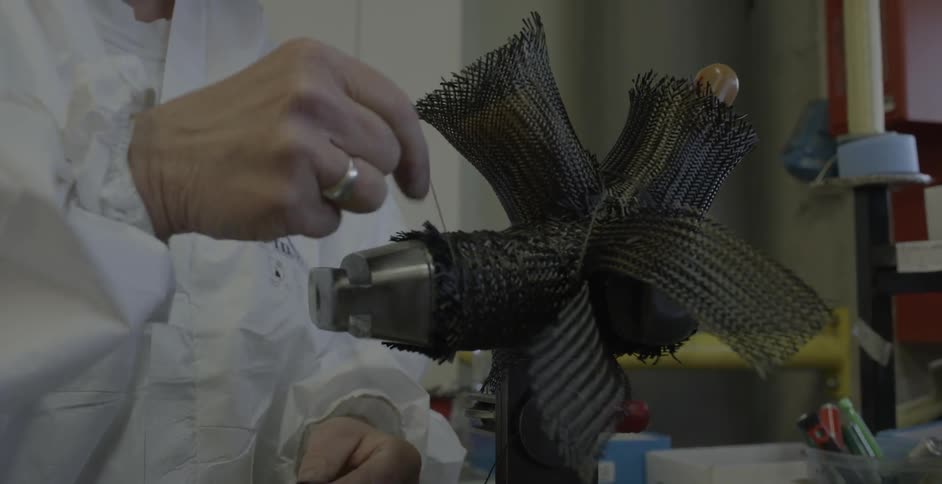 Person  winding thin material in a workshop