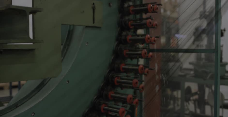 A machine moves and works with thread